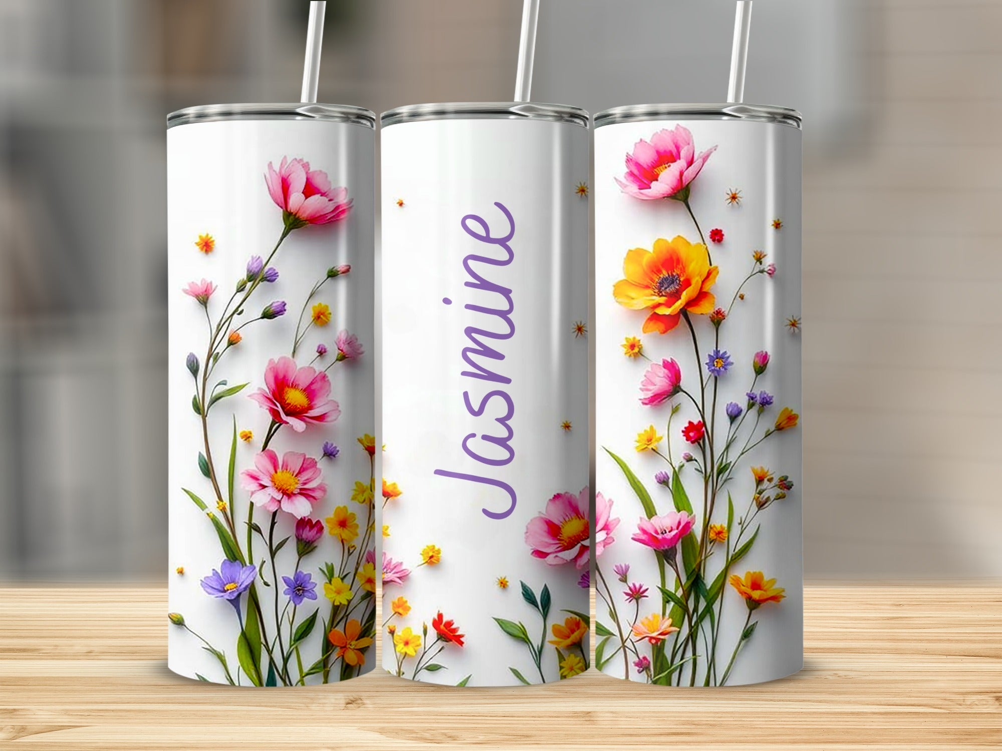 Three tumblers with floral designs and the name "Jasmine" on the middle tumbler.