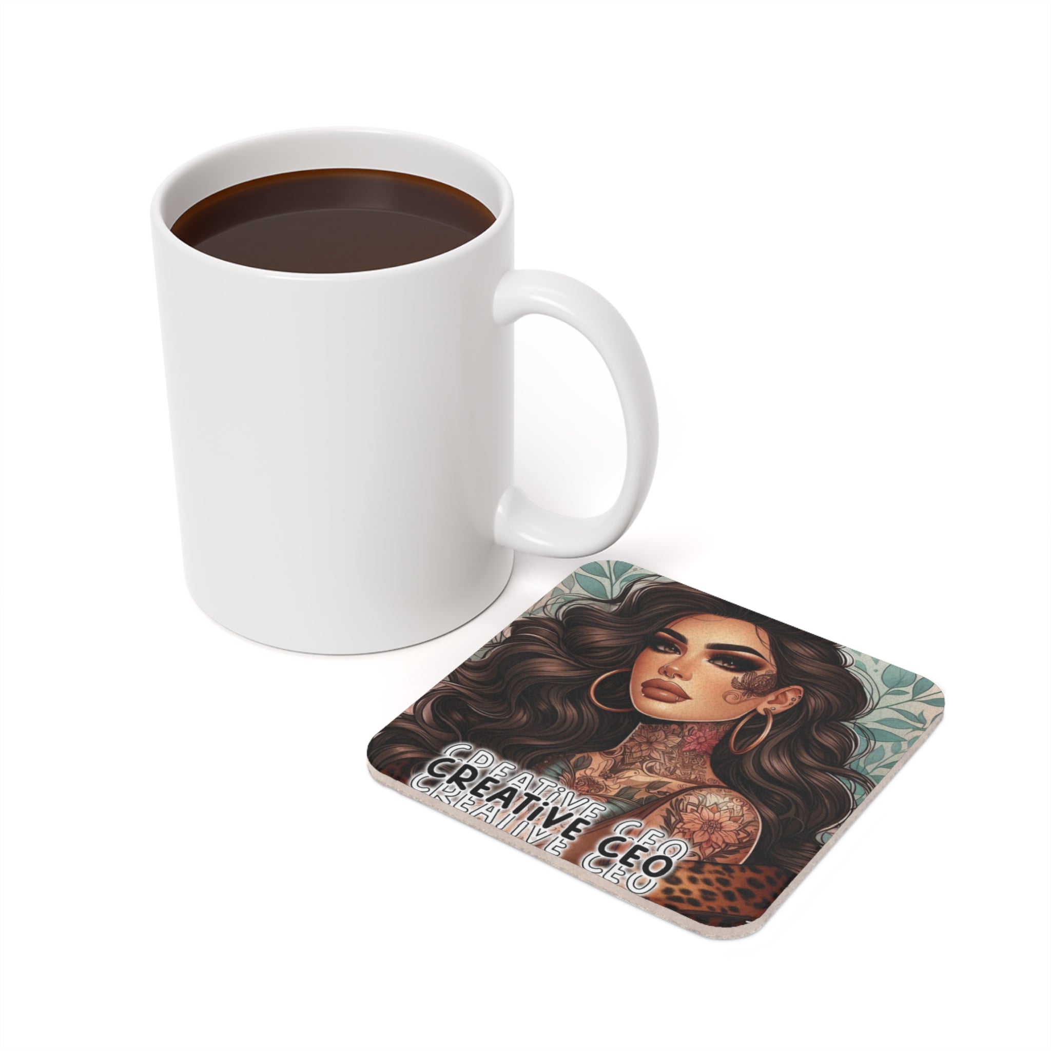 White mug next to a square coaster with a tattooed woman and "CREATIVE CEO" text.