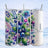 Tumbler with blueberries, leaves, and floral designs.