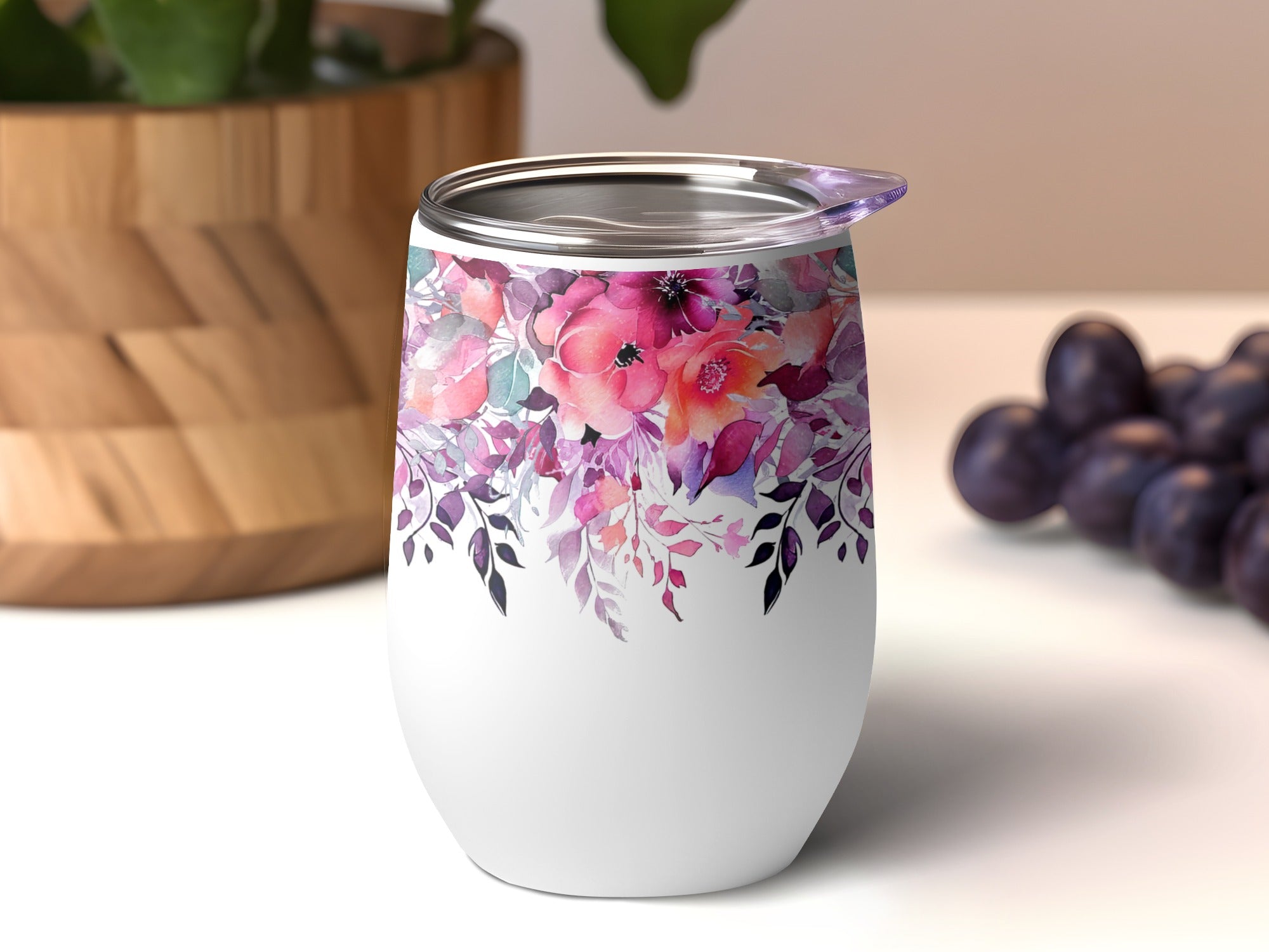 White stemless wine tumbler with colorful floral design.