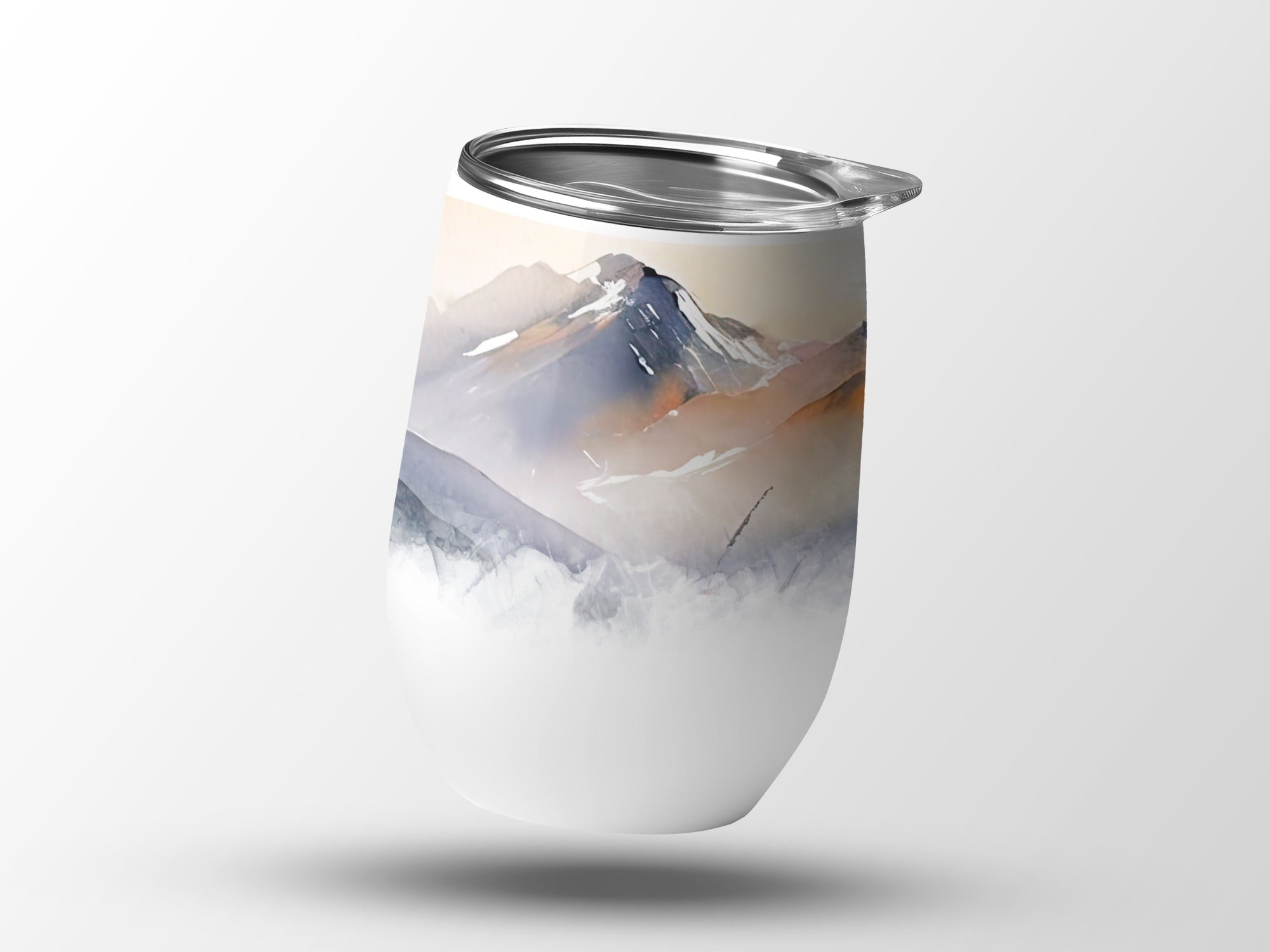 White tumbler with watercolor mountain landscape design.