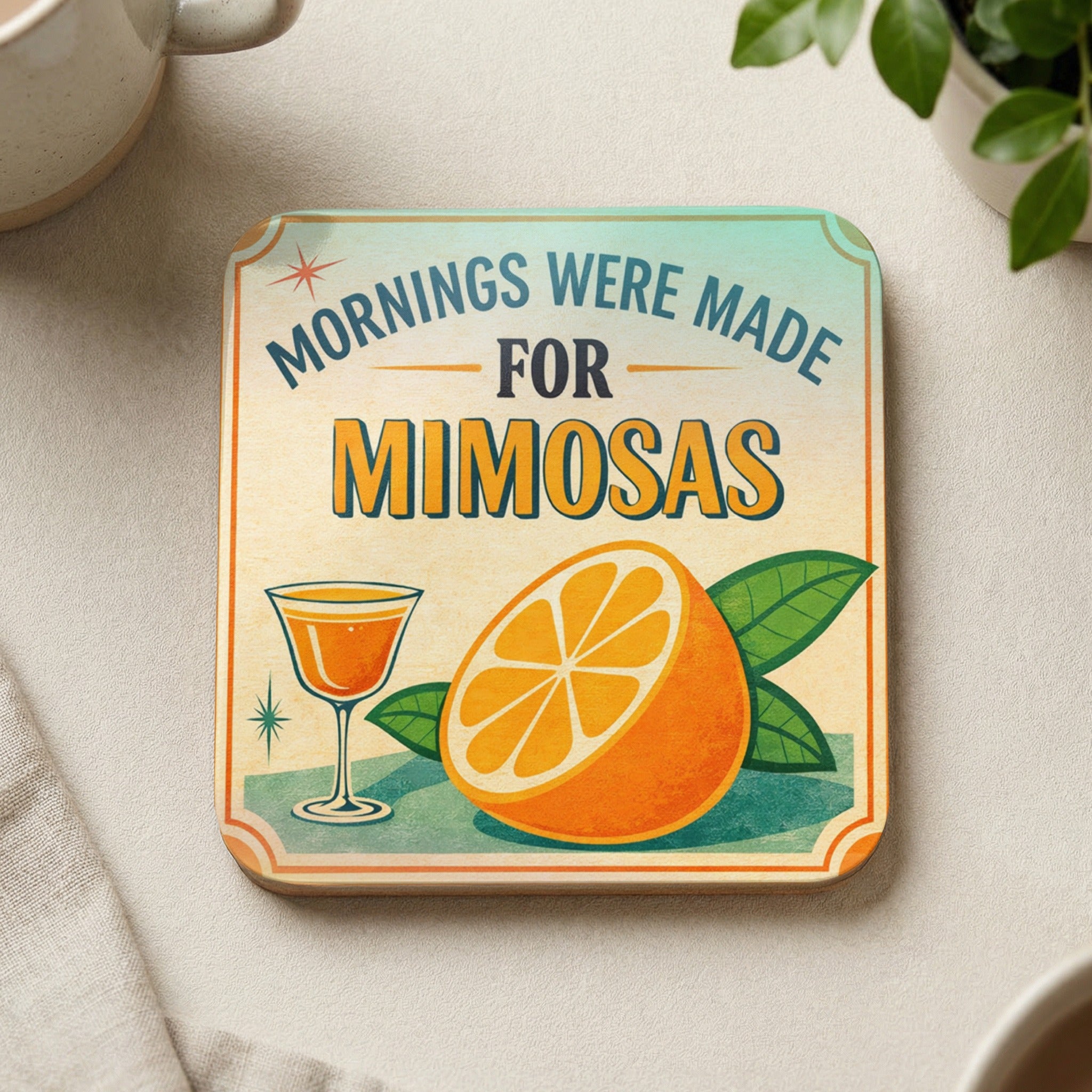 Square coaster with "Mornings Were Made For Mimosas" text, an orange slice, and a cocktail glass.