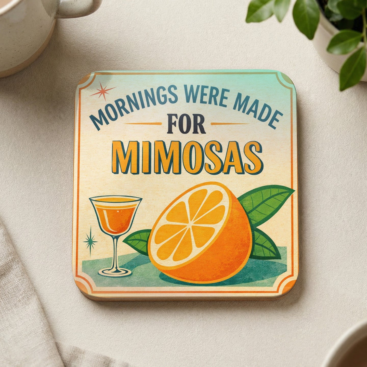 Square coaster with "Mornings Were Made For Mimosas" text, an orange slice, and a cocktail glass.