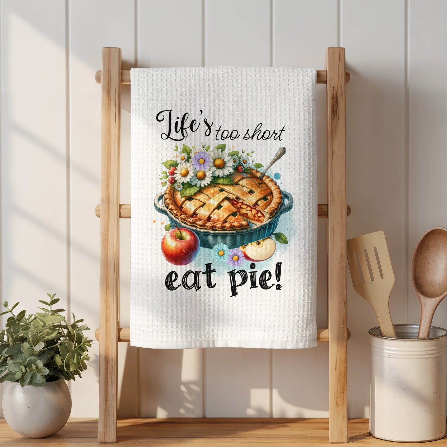 Woven kitchen towel with watercolor pie and apples, reads "Life's too short eat pie!".