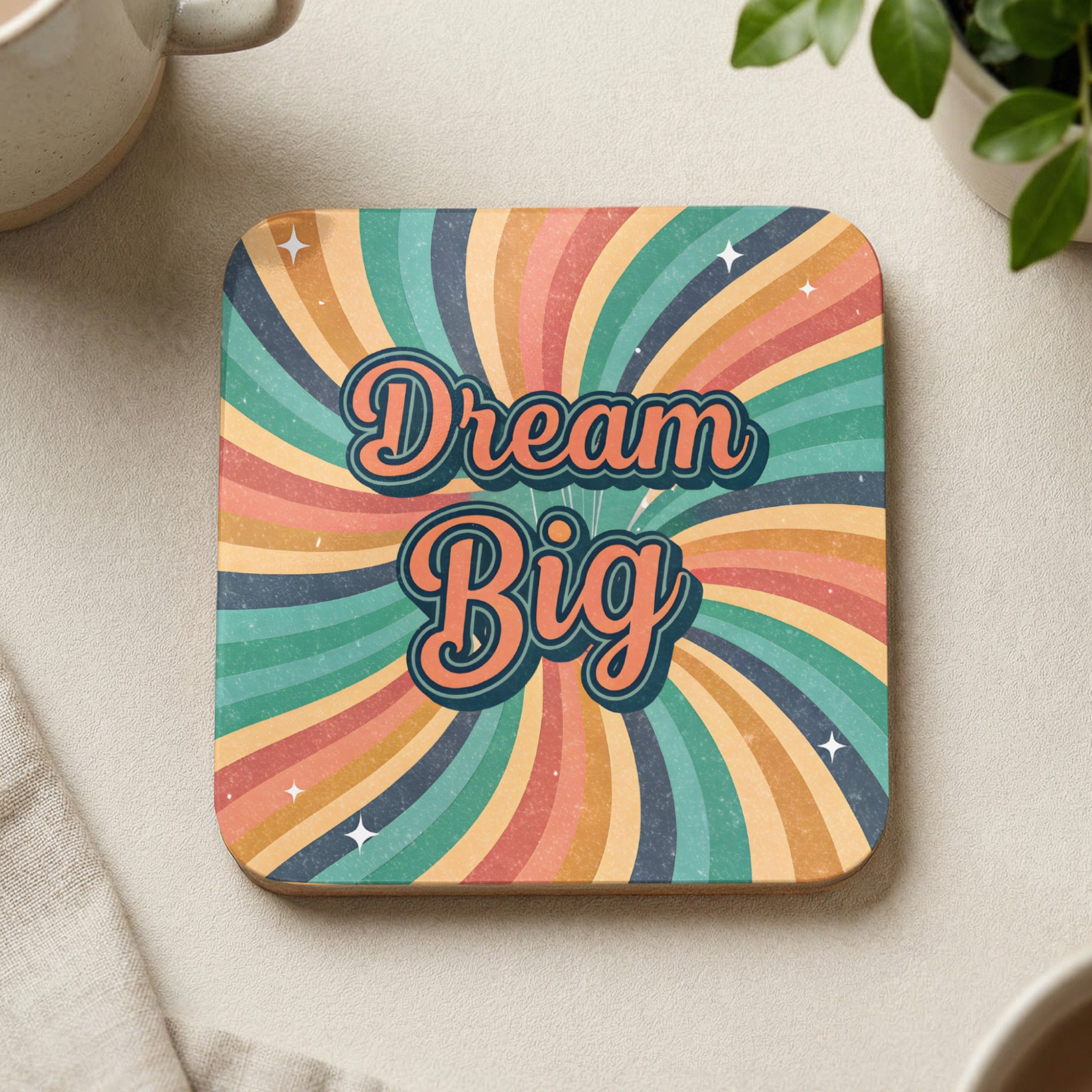 Square coaster with "Dream Big" text on a retro sunburst background.