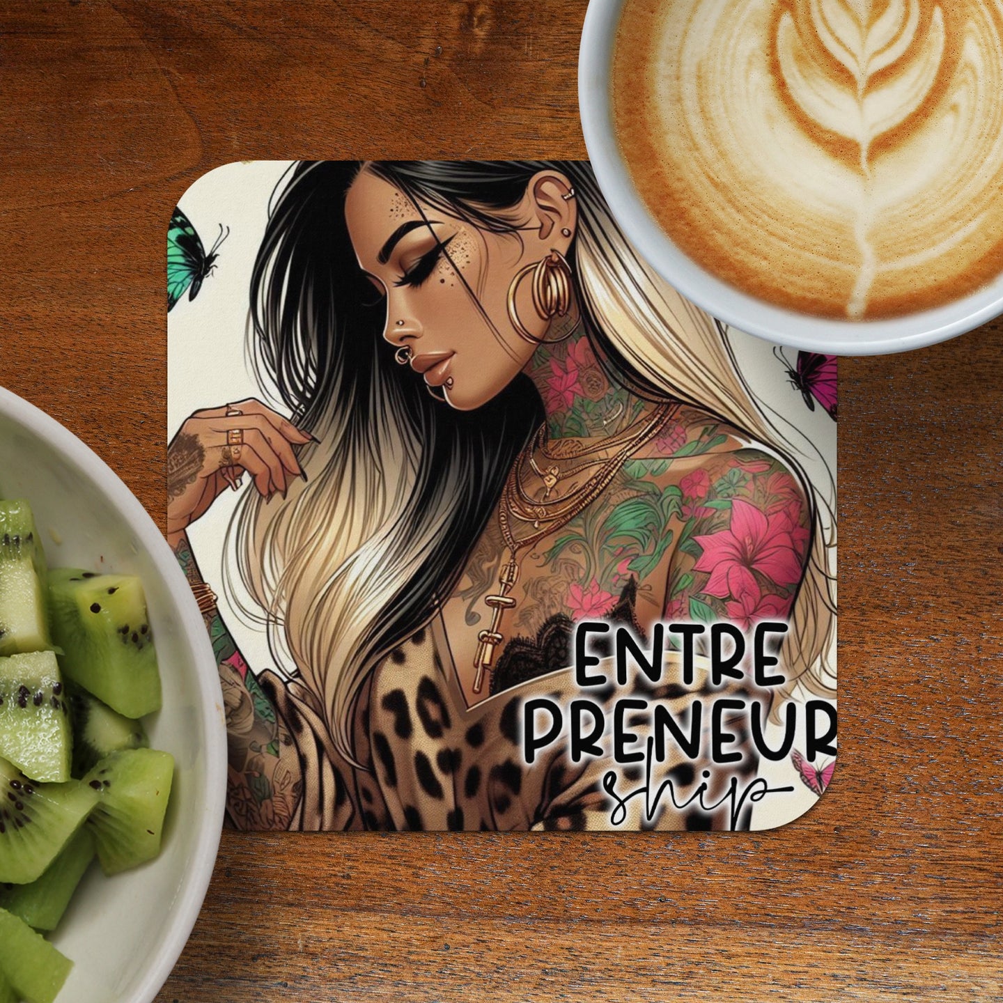 Tattooed woman with leopard print shirt and "Entrepreneurship" text on wooden table.