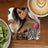 Tattooed woman with leopard print shirt and "Entrepreneurship" text on wooden table.