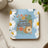 Simply Blessed cross with flowers and leopard print design on blue coaster.
