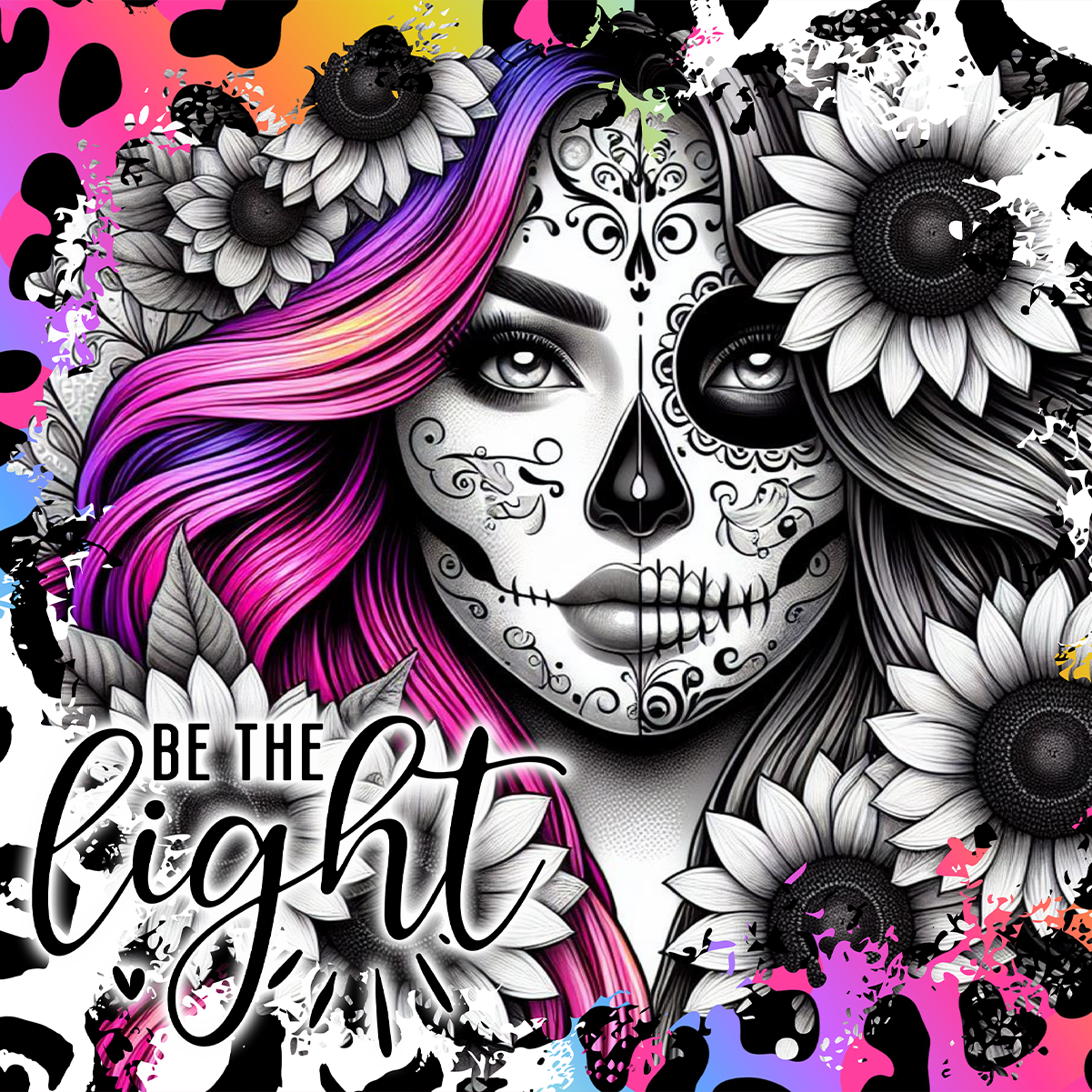 Sugar skull woman with vibrant pink hair, sunflowers, and "Be The Light" text.
