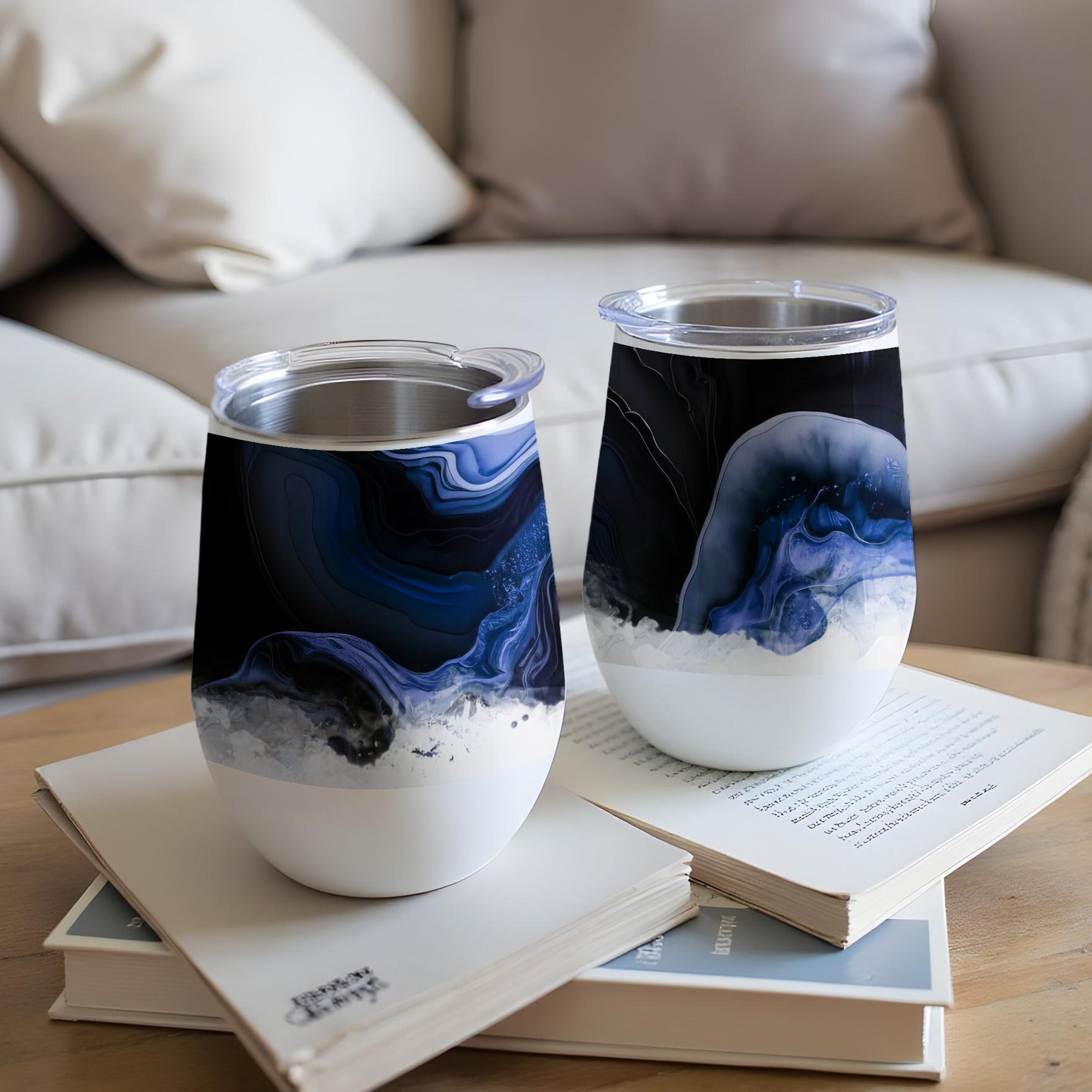 Two white wine tumblers with abstract blue and white marbling design.