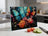 Glass cutting board with two colorful butterflies and flowers.
