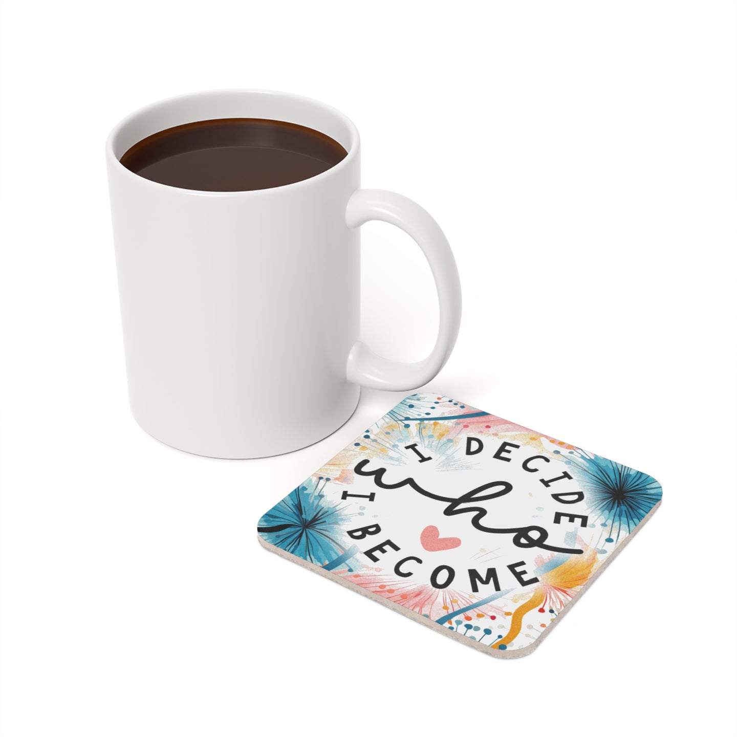 White mug of coffee next to a coaster with text "I decide who I become".
