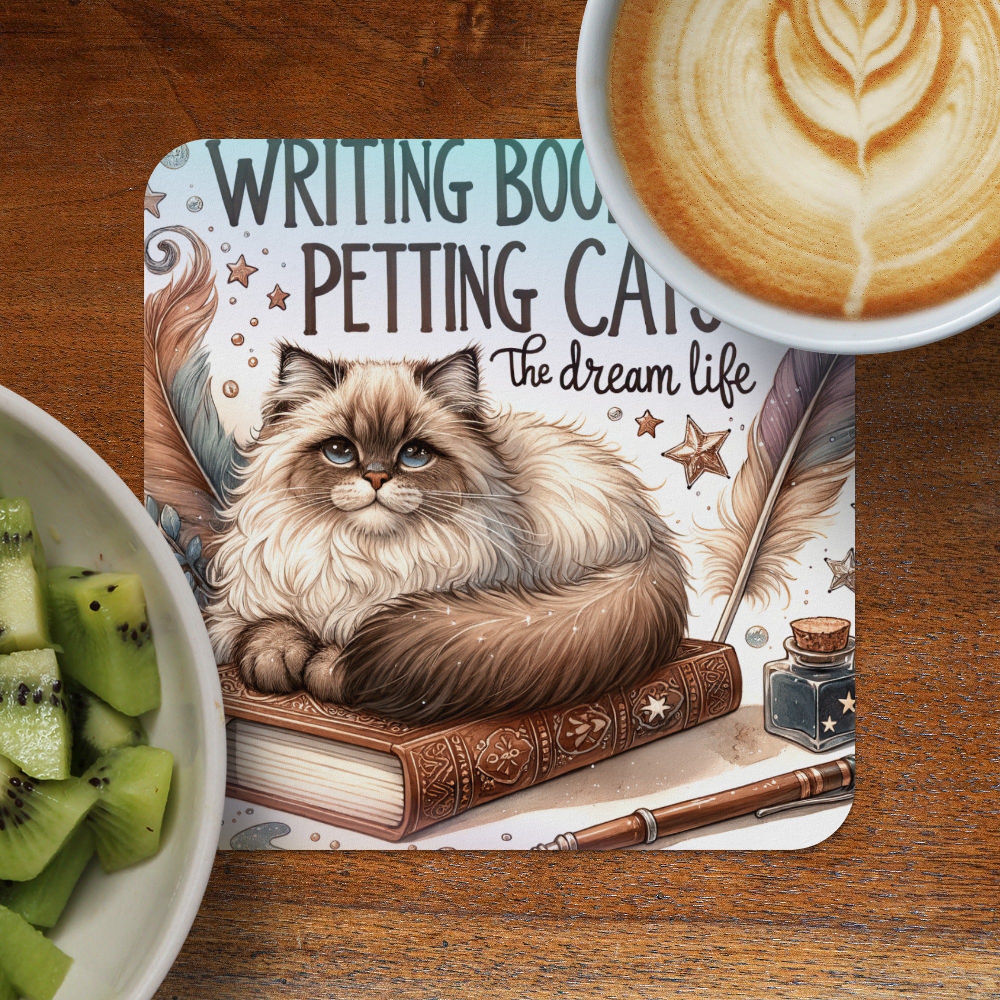 Fluffy cat on book with "Writing Books Petting Cats The Dream Life" text.