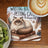 Fluffy cat on book with "Writing Books Petting Cats The Dream Life" text.
