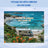 Camper van parked on a beach with "Home is where we park it!" text.