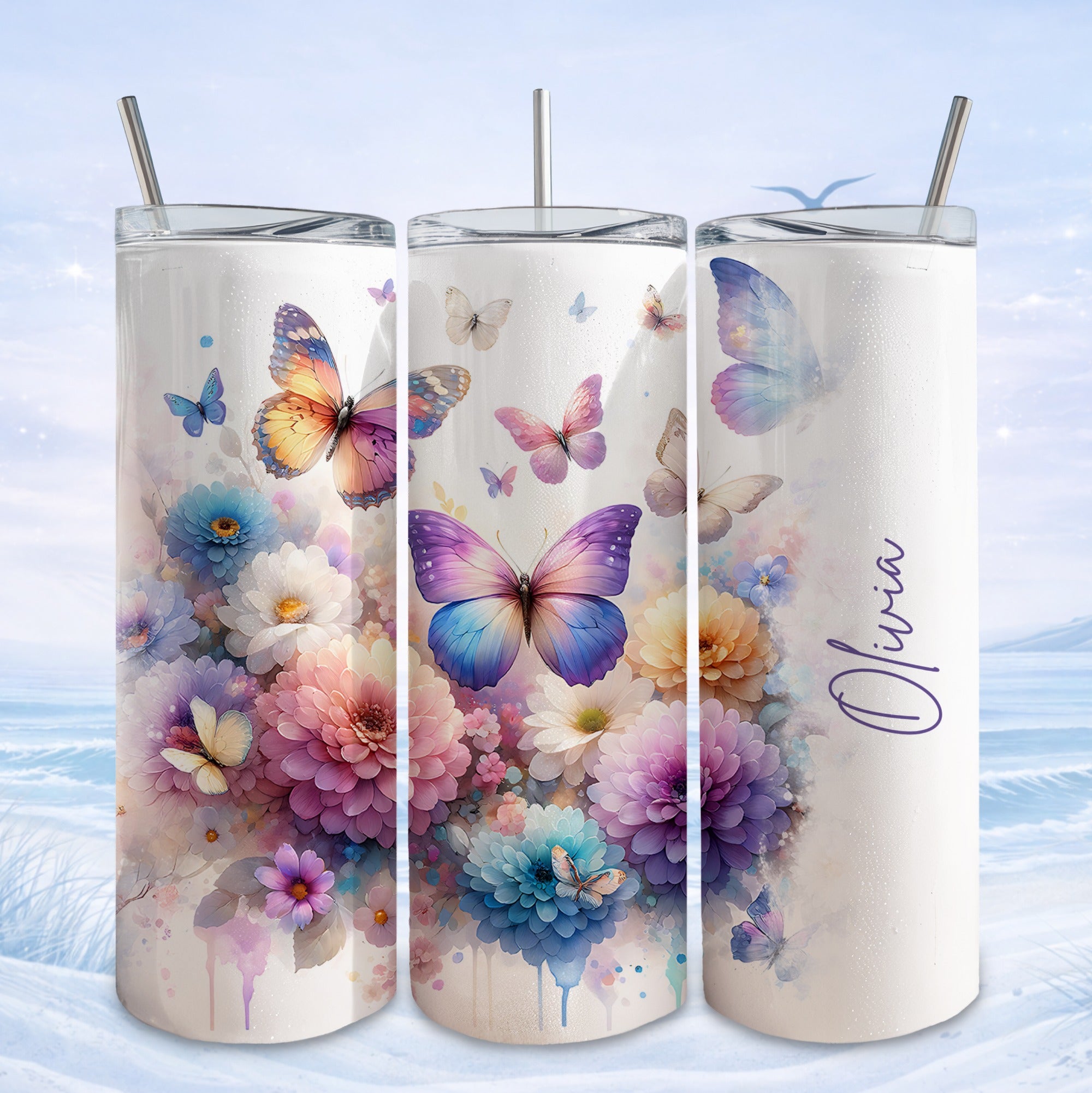 Three tumblers decorated with colorful butterflies and floral designs.
