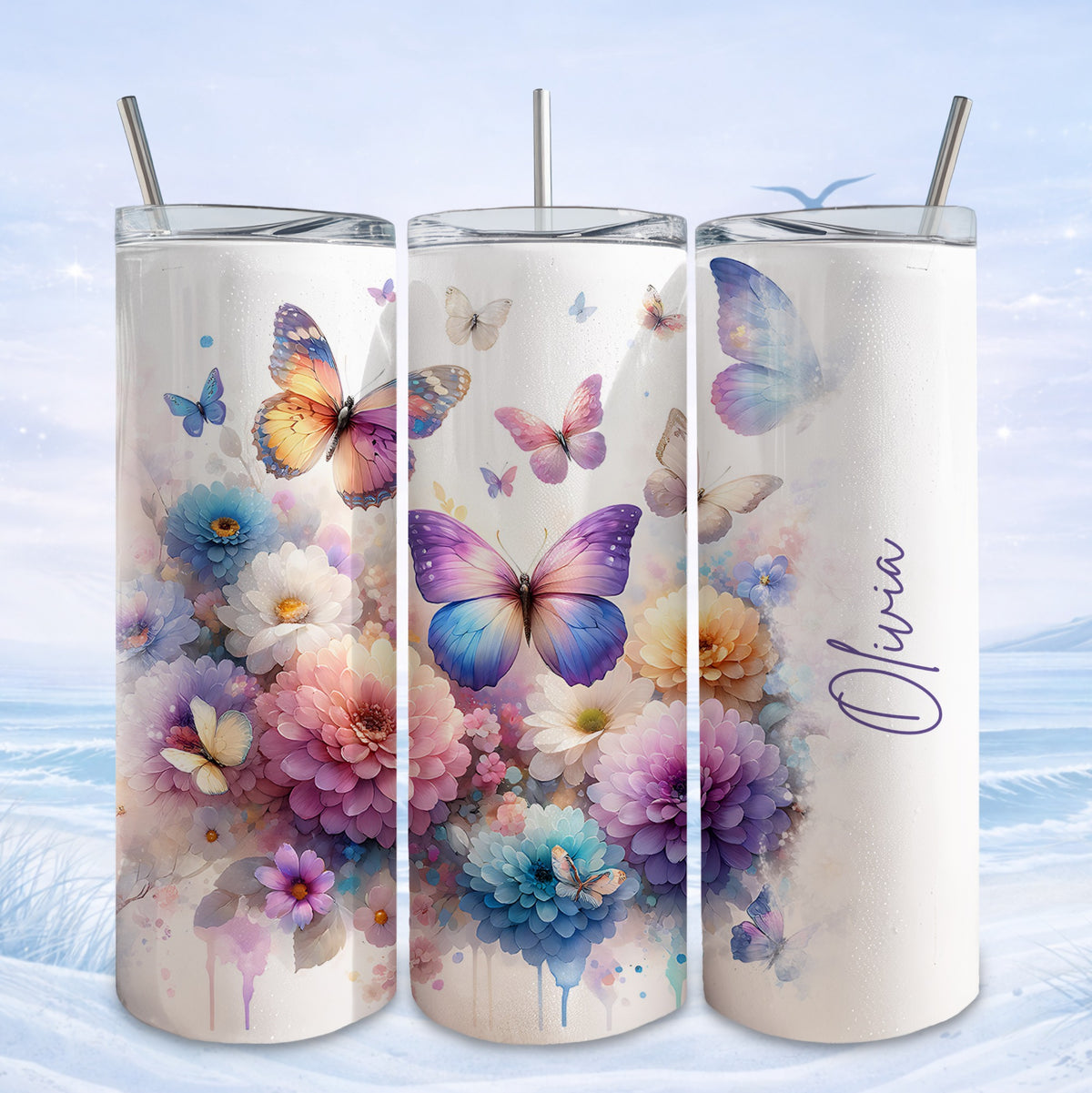 Three tumblers decorated with colorful butterflies and floral designs.