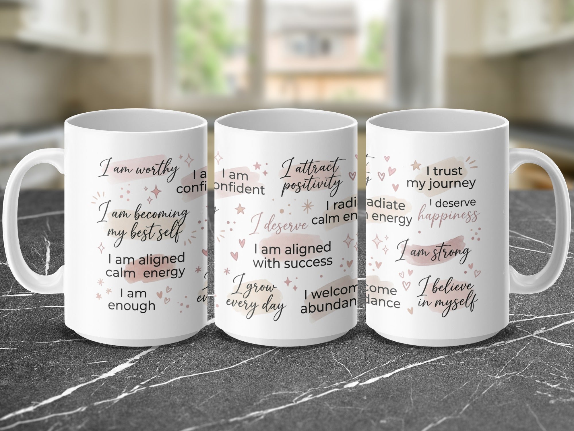 Three mugs with positive affirmations: "I am worthy," "I attract positivity," and "I trust my journey."