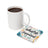 White mug of coffee next to a coaster with "I am right where I am supposed to be" text.