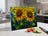 Stained glass cutting board with two sunflowers on a kitchen counter.