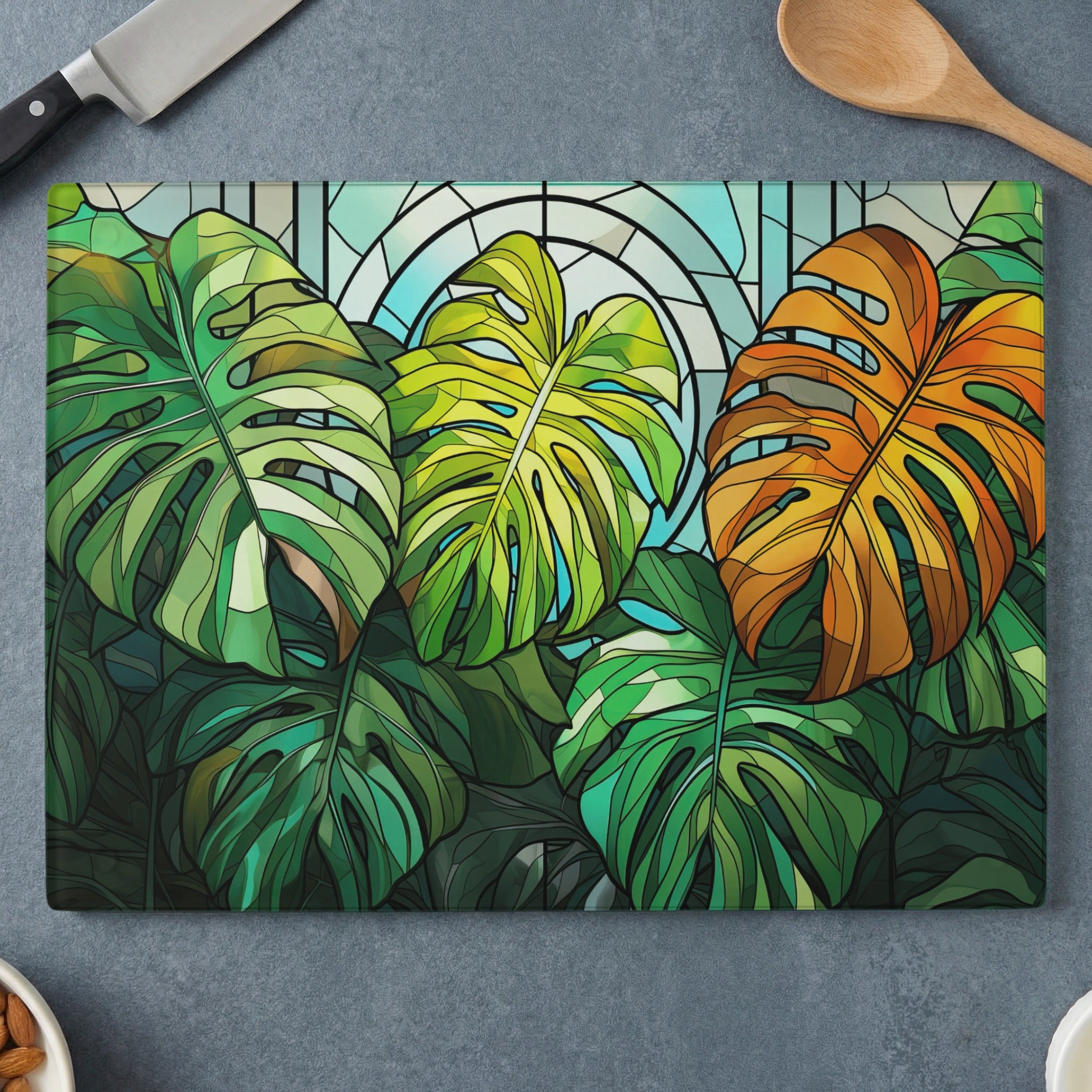 Monstera leaves in green, yellow, and orange with stained glass pattern.