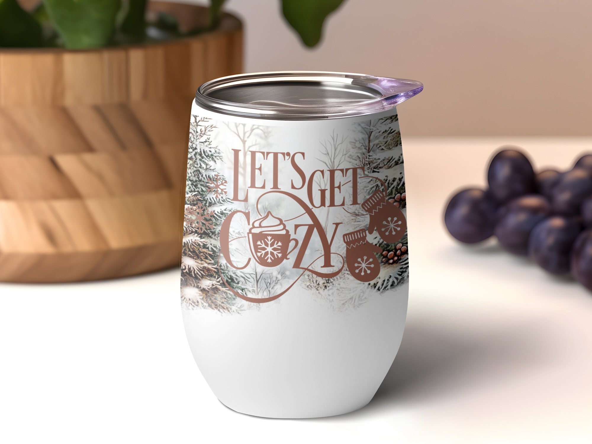 Wine tumbler with "Let's Get Cozy" text and winter tree and mitten graphics.
