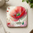 Square coaster with a large red poppy and the text "Act NOW".