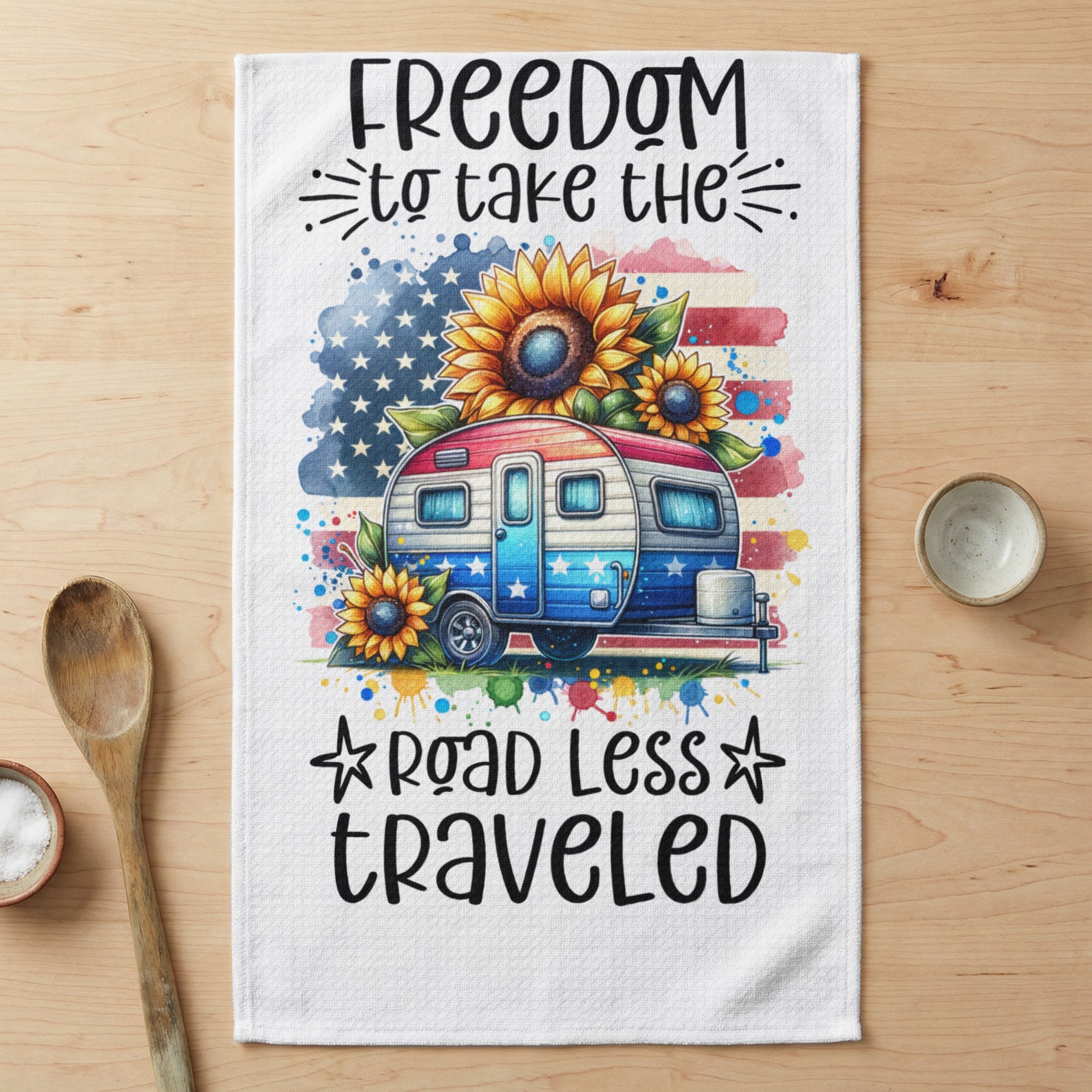 RV with American flag, sunflowers, and text "Freedom to take the road less traveled".