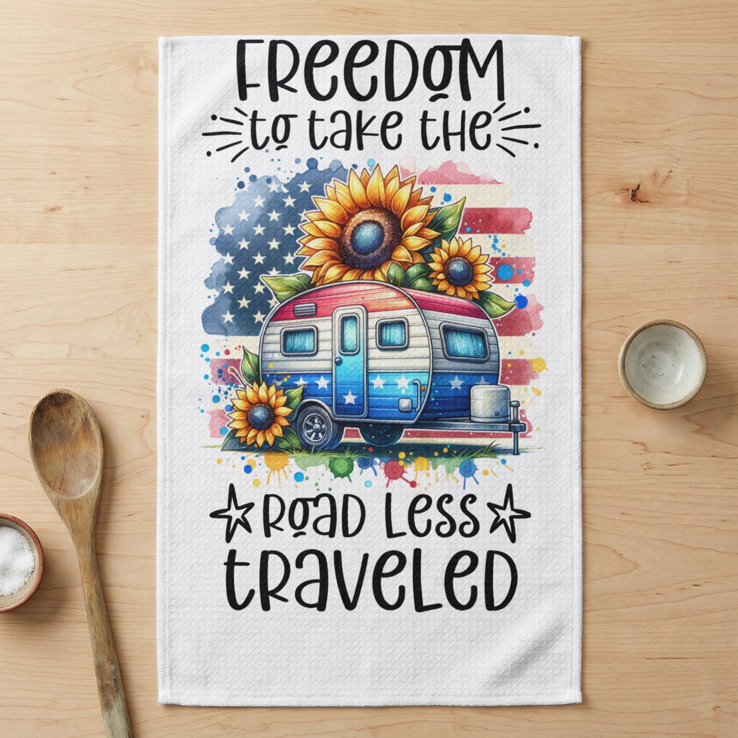 RV with American flag, sunflowers, and text "Freedom to take the road less traveled".