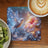 Hummingbird with glowing wings on a celestial floral background next to coffee and kiwi.