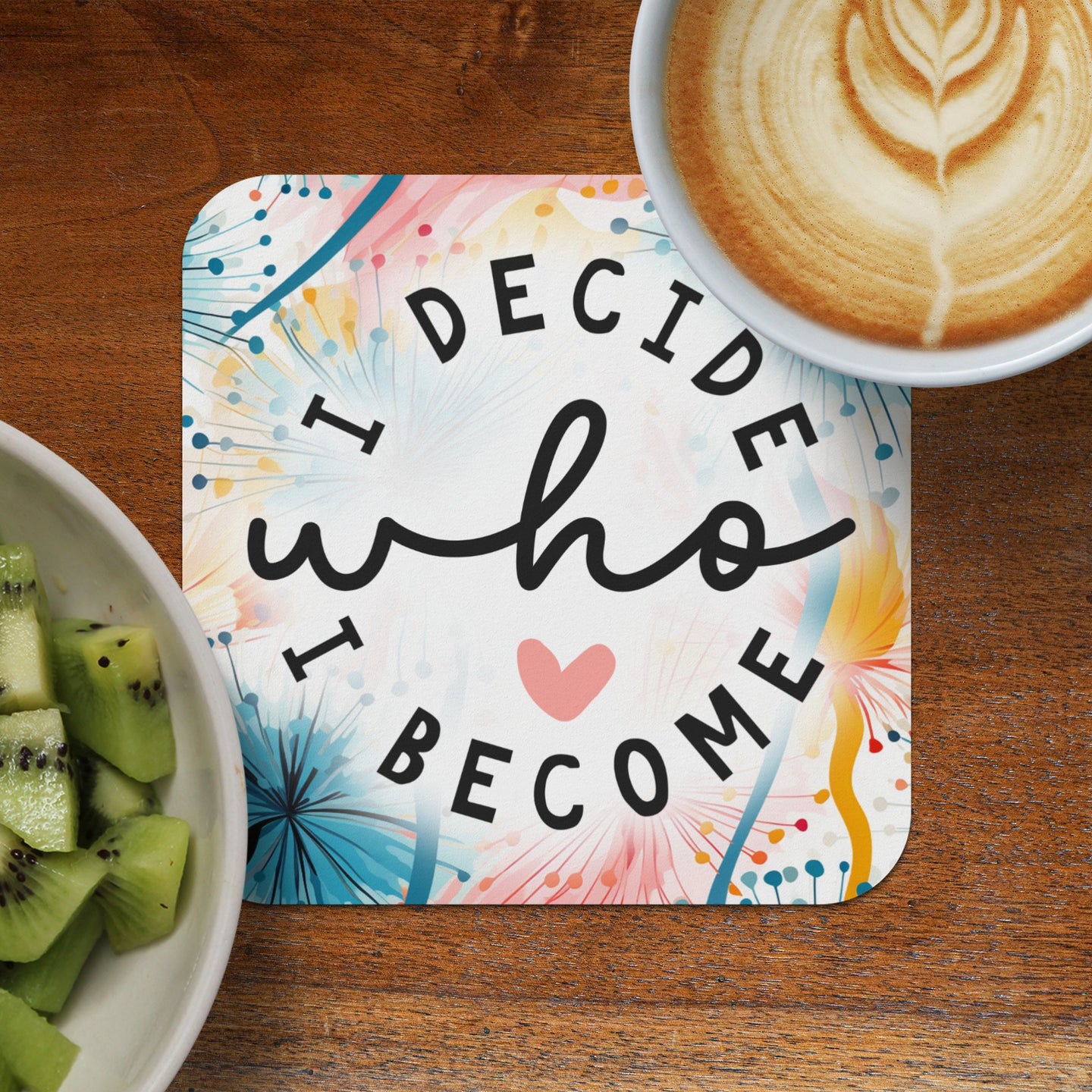 Coaster with quote "I DECIDE WHO I BECOME" and latte art, served with kiwi.