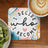 Coaster with quote "I DECIDE WHO I BECOME" and latte art, served with kiwi.