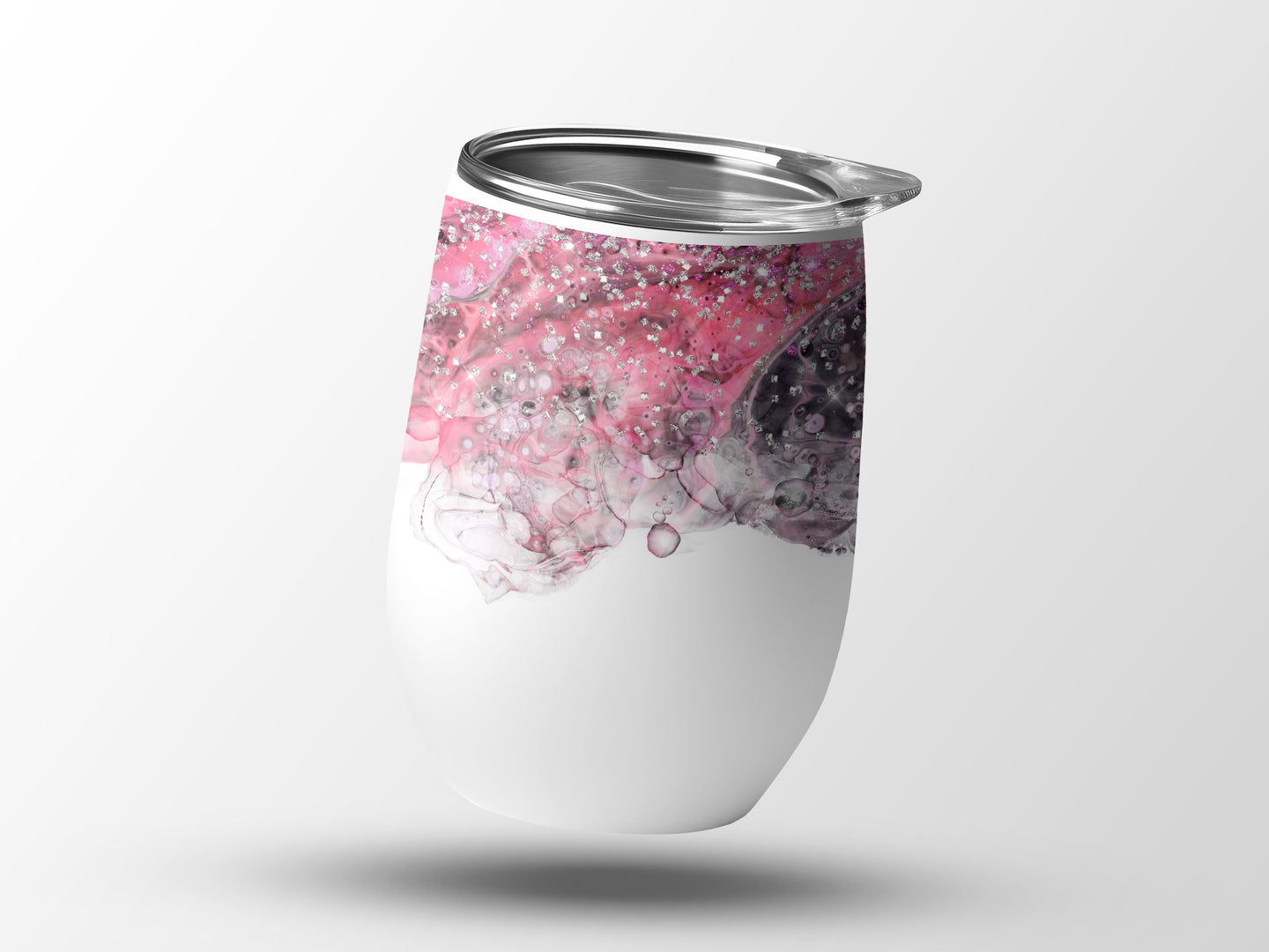 White tumbler with pink and silver abstract design.
