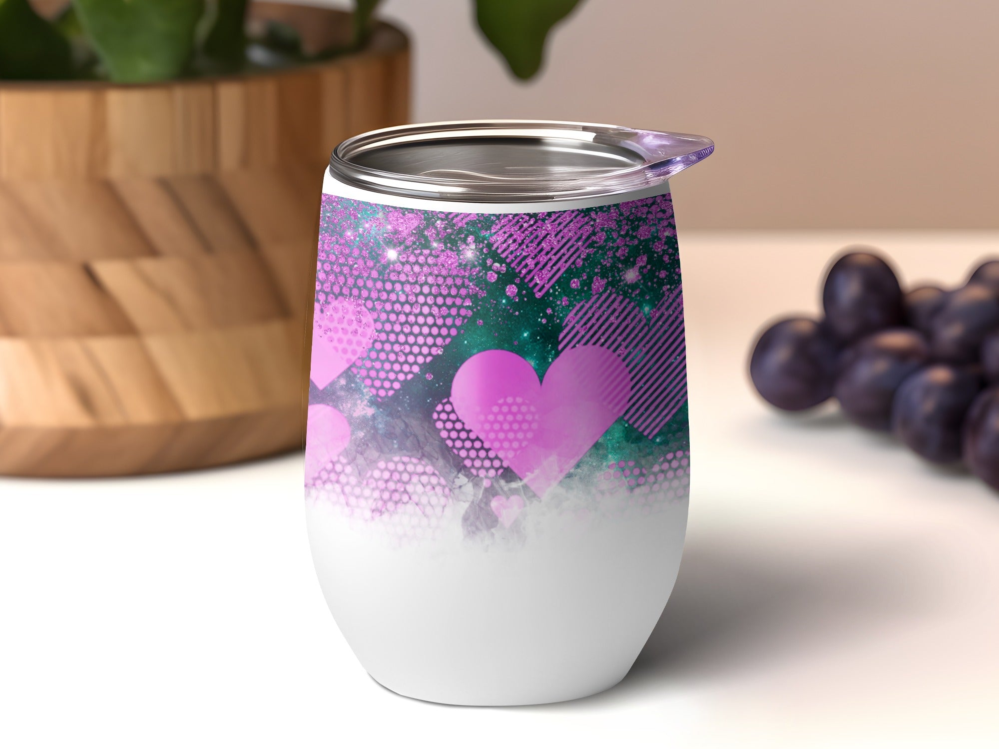White tumbler with pink glitter and heart pattern.
