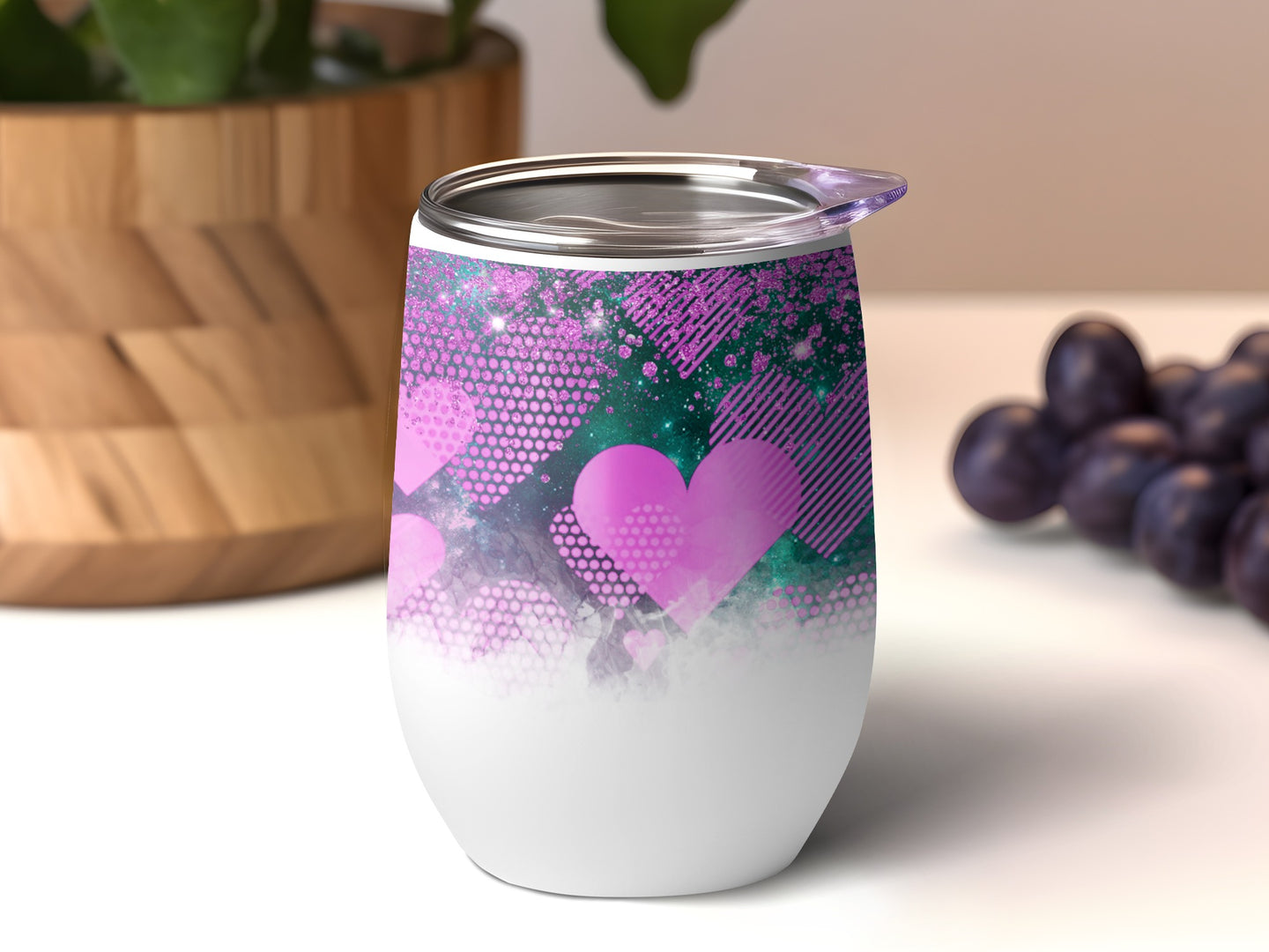 White tumbler with pink glitter and heart pattern.