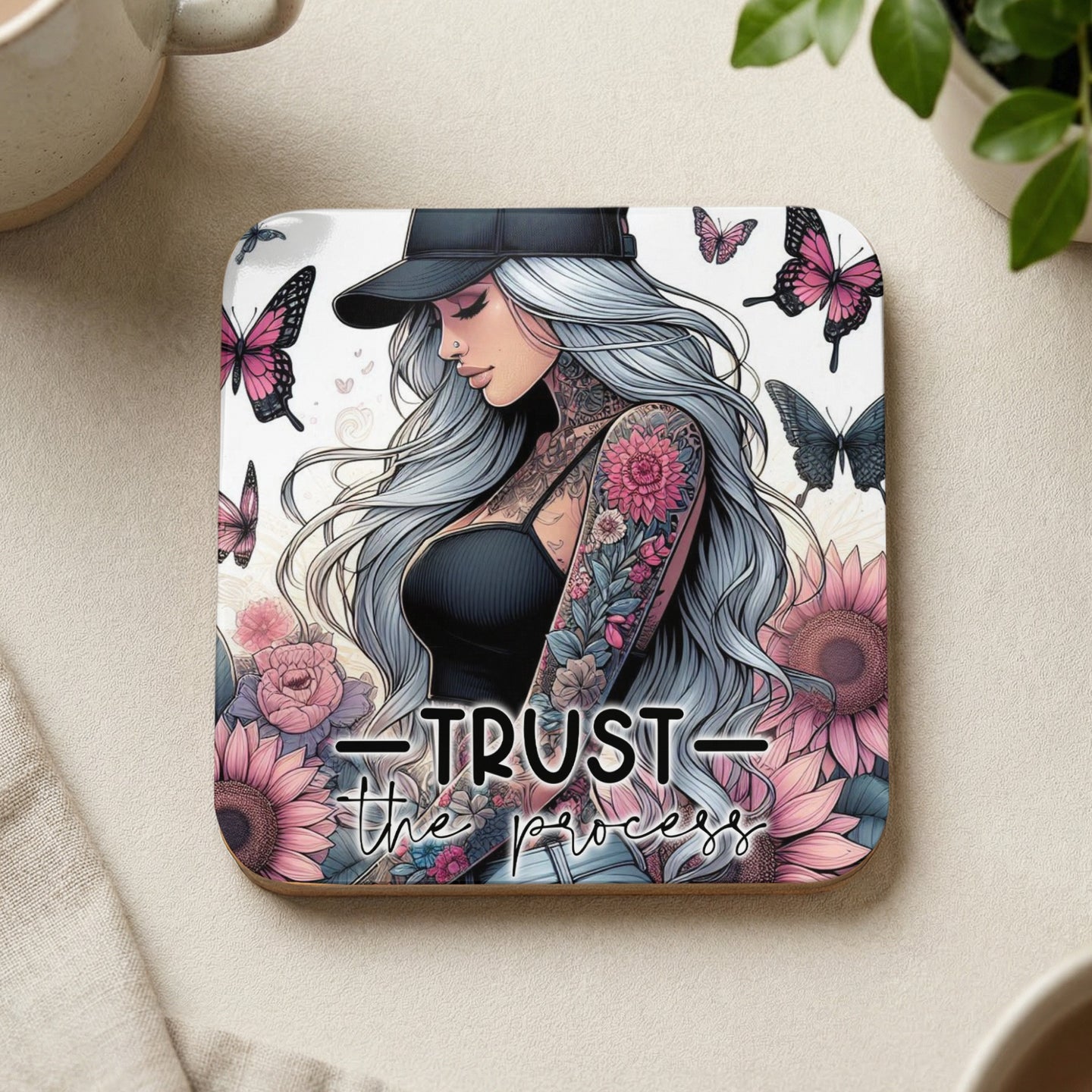Tattooed woman with long gray hair and butterflies, "Trust the process" text.