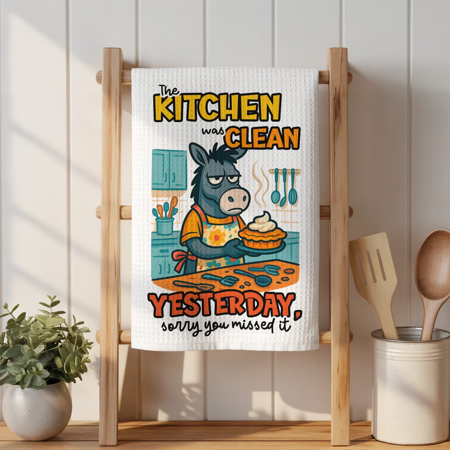 Donkey wearing apron holding pie, text reads "The kitchen was clean yesterday, sorry you missed it".