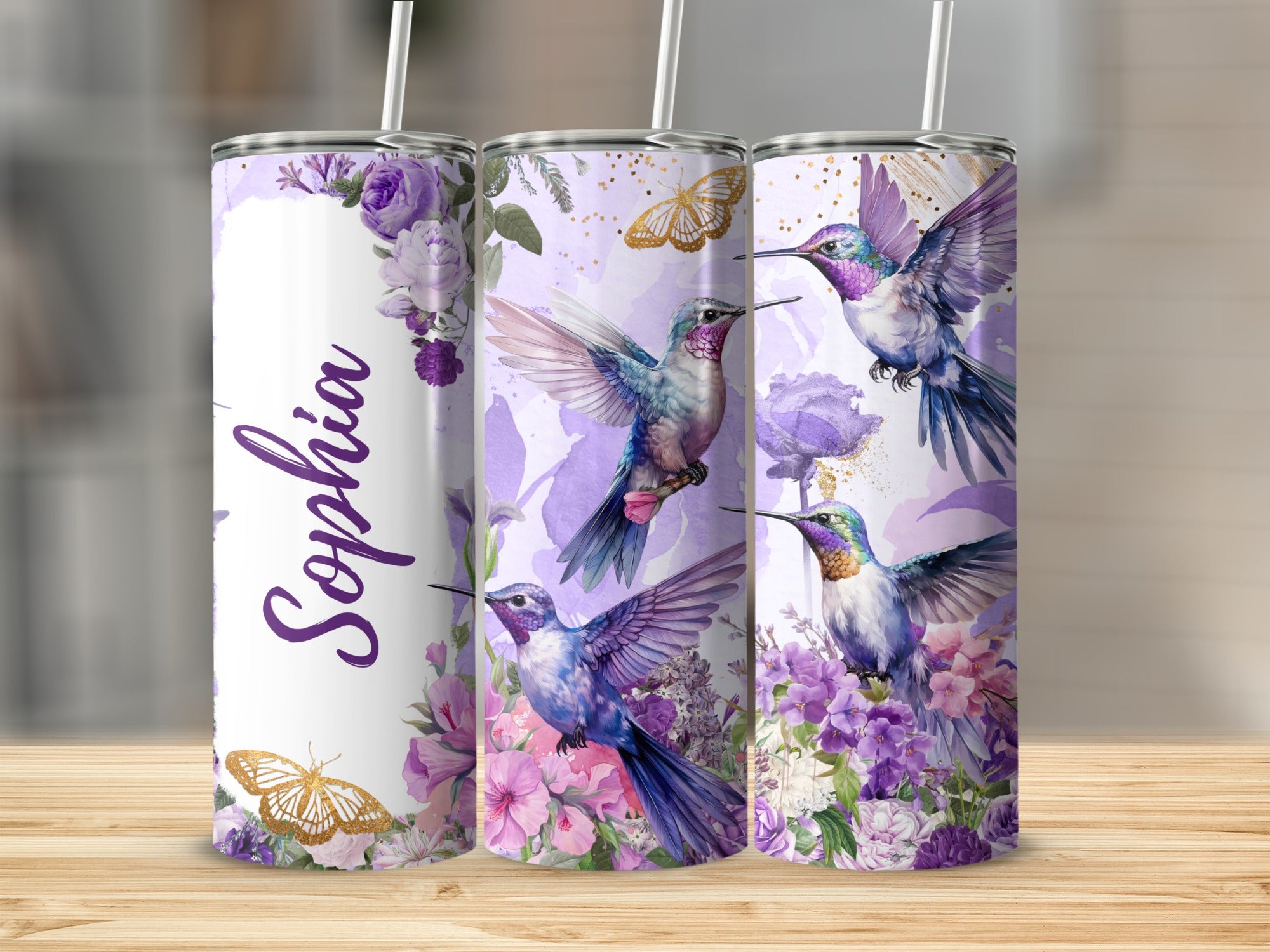 Hummingbirds and butterflies on a purple floral tumbler with "Sophia" text.