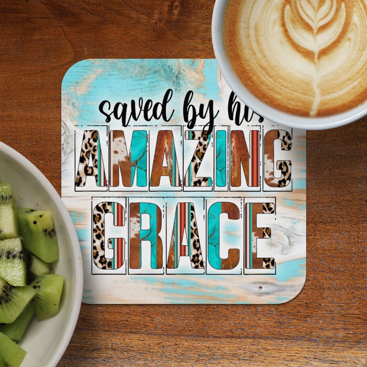 Coaster with "saved by his AMAZING GRACE" text on distressed wood background.