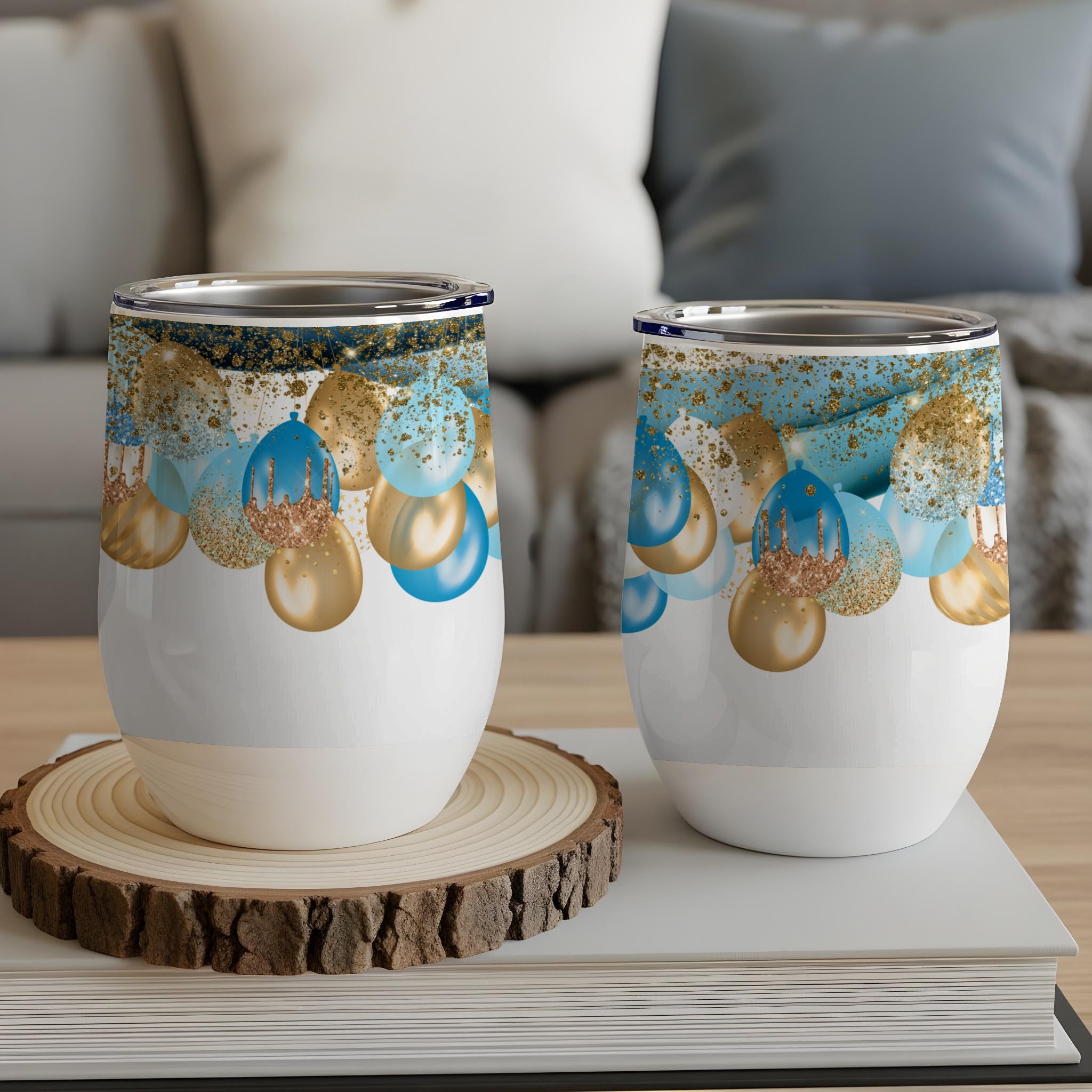 Two wine tumblers with blue and gold balloon design.