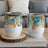 Two wine tumblers with blue and gold balloon design.