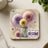 Coaster with dandelions, butterflies, and text "My thoughts become my reality".