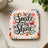 Coaster with "Smile and Shine" text and colorful butterflies.