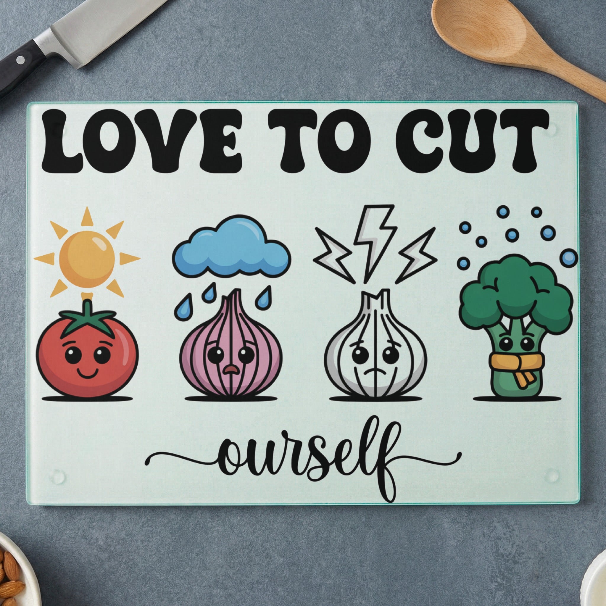 Cutting board with cartoon vegetables and "Love to Cut Ourselves" text.