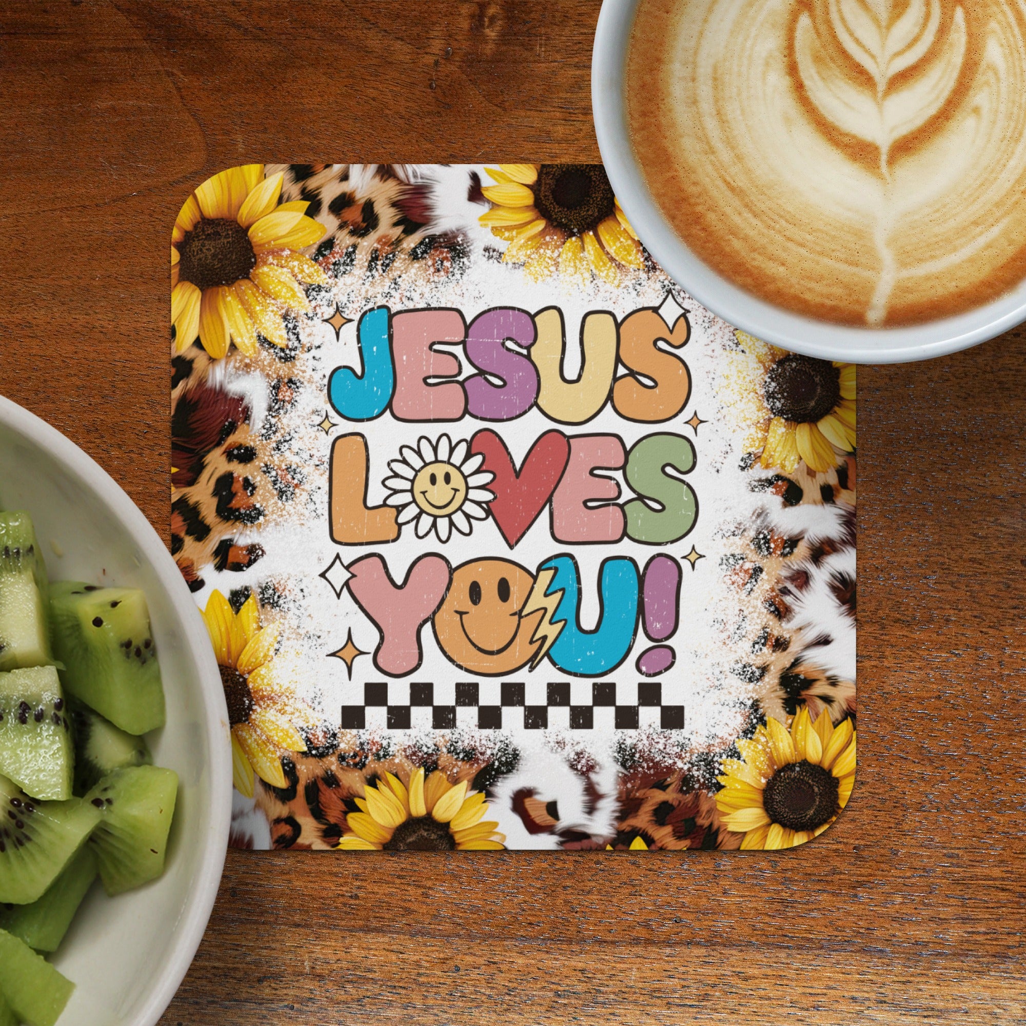 Jesus Loves You! text on a coaster with sunflowers and leopard print.