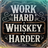 Wooden sign with text "Work Hard Whiskey Harder" in distressed white lettering.