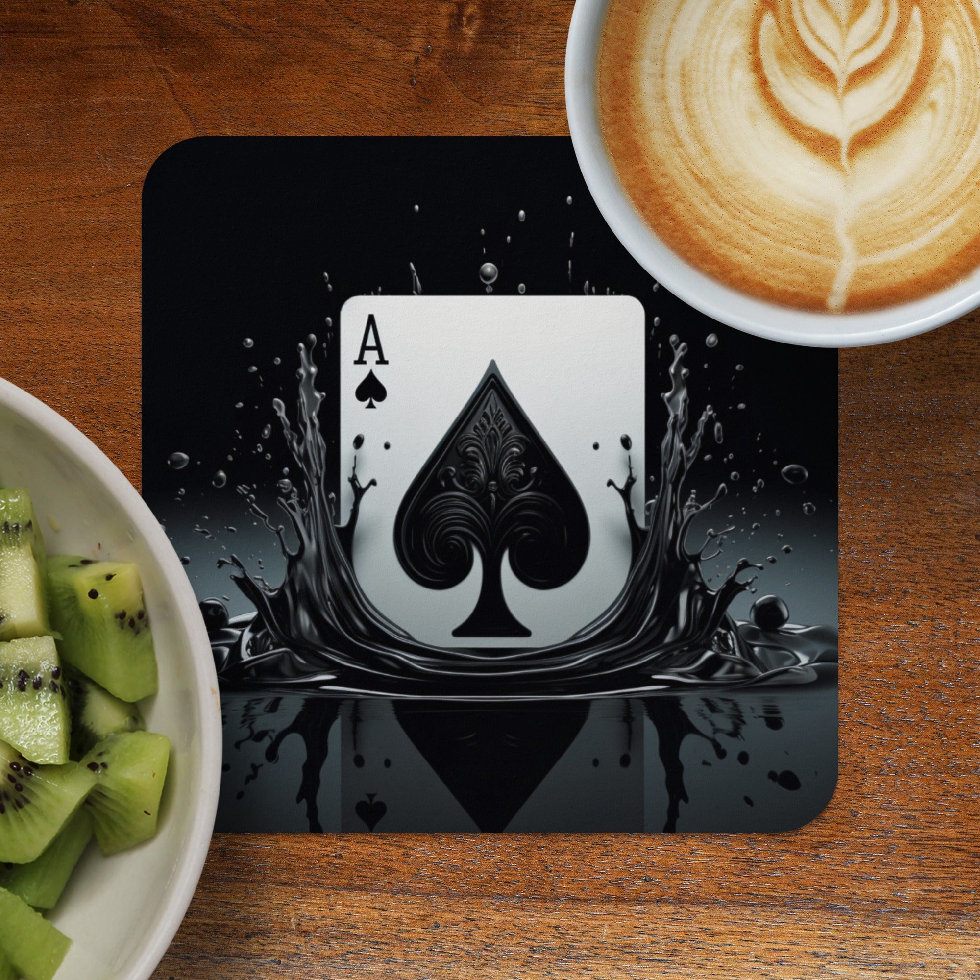 Ace of Spades playing card design on a black coaster with splashing liquid.