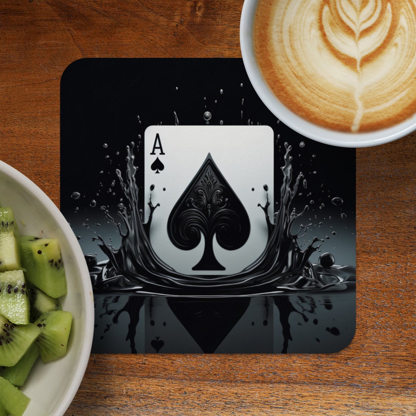 Ace of Spades playing card design on a black coaster with splashing liquid.