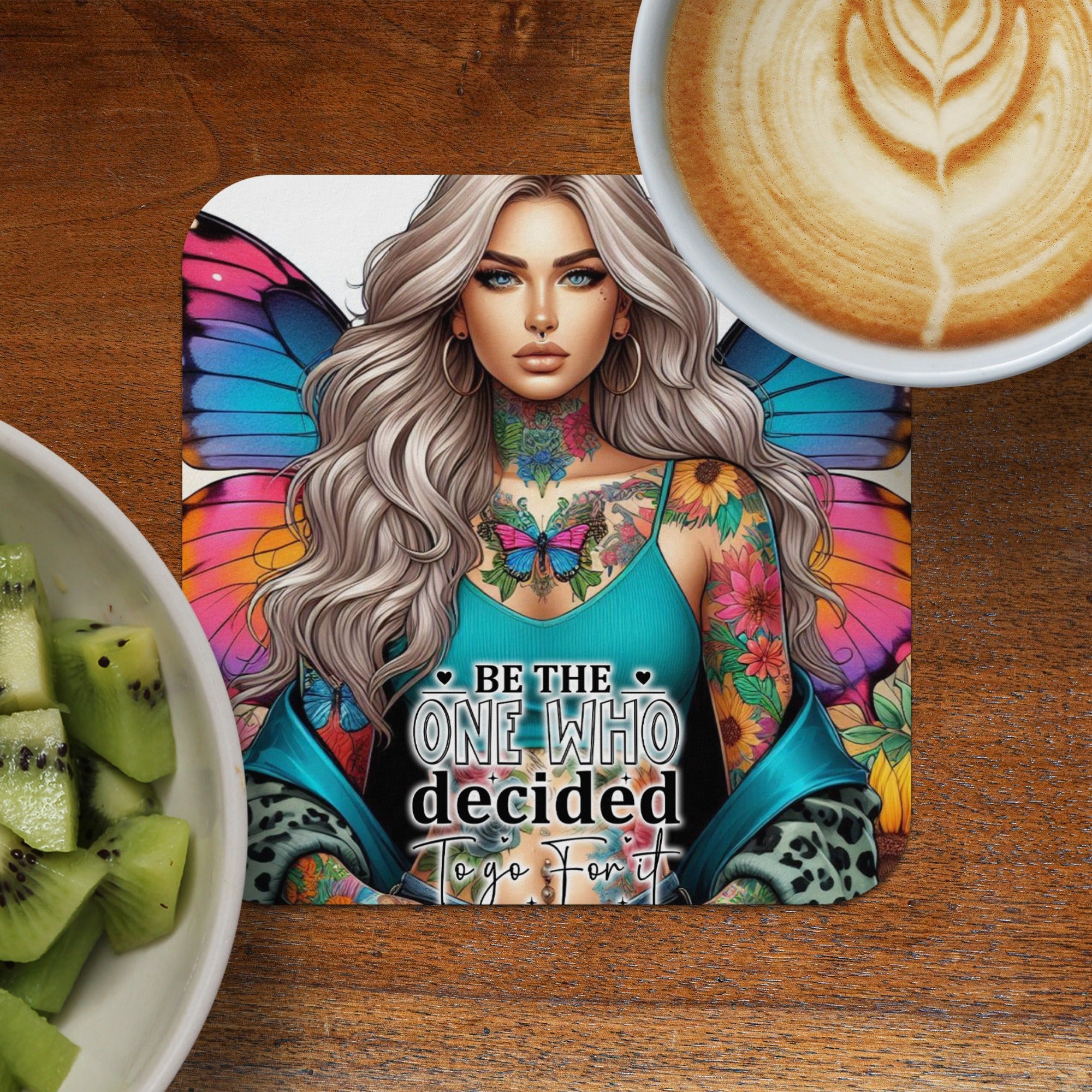 Woman with butterfly wings and tattoos, saying "Be the one who decided to go for it."