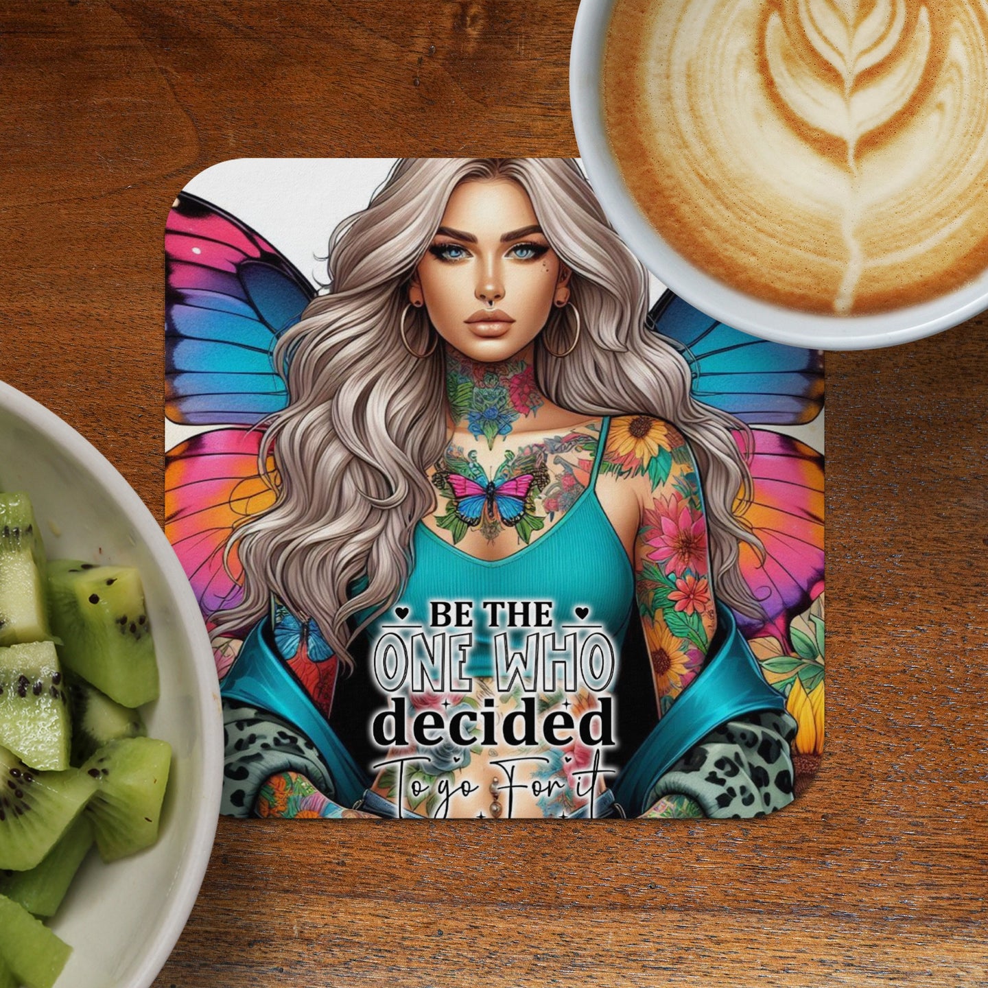 Woman with butterfly wings and tattoos, saying "Be the one who decided to go for it."